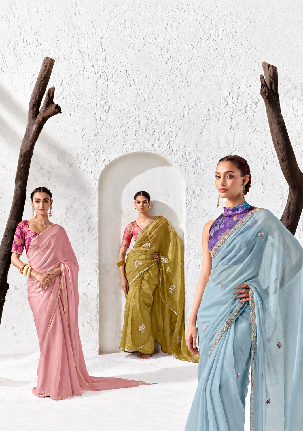 Editorial portrait of a woman wearing a purple saree with a gold border against a red backdrop
